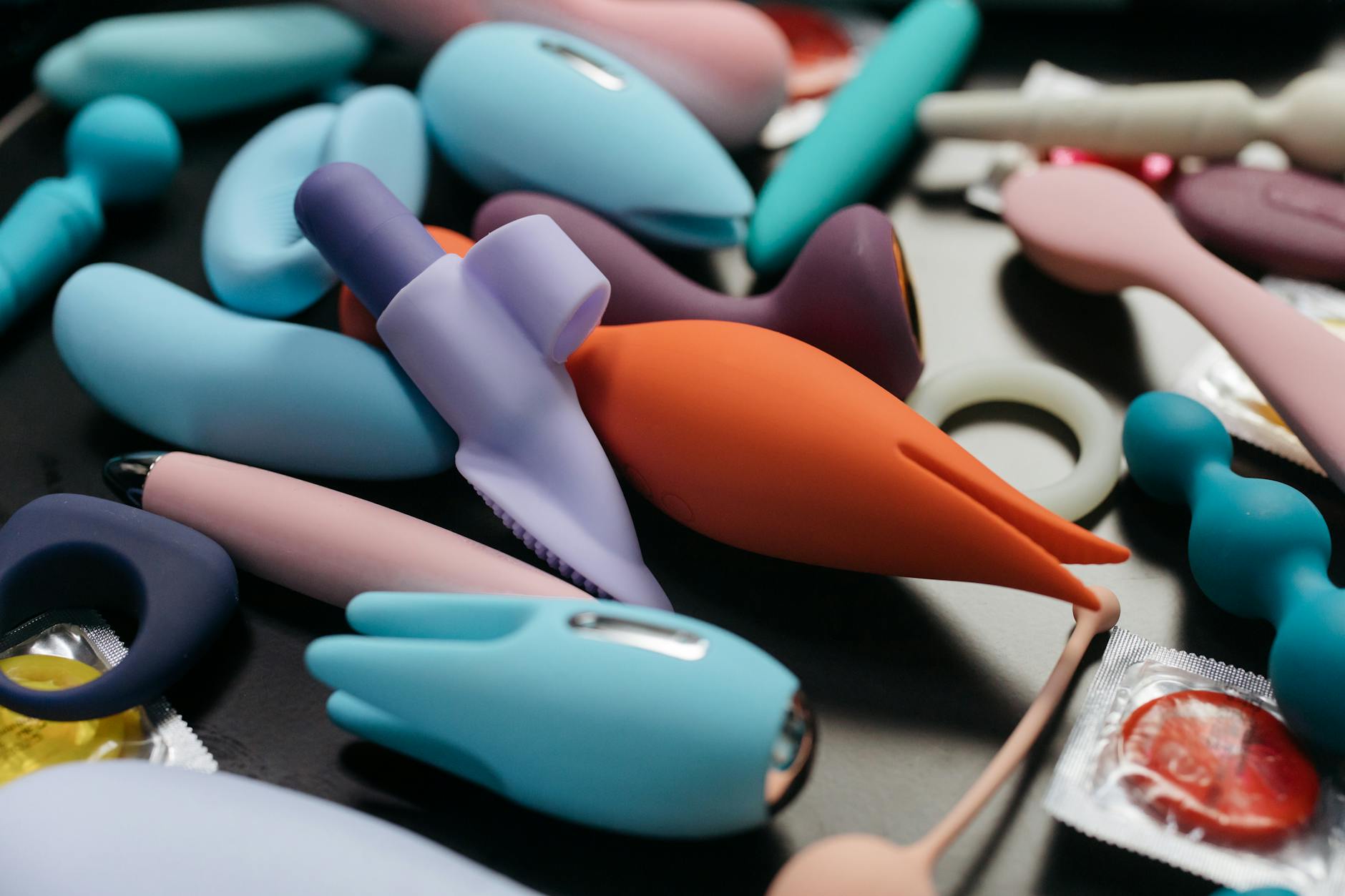 A collection of vibrant adult toys and clitoral vibrators in various shapes, showcasing design options for pleasure exploration